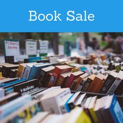 Decorative image of books on a sale table.