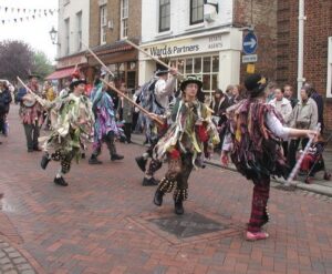 Image of Morris Dancers performing in the street.