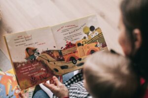 Mom and child reading a children's book together.